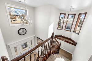 Stairs with a notable chandelier