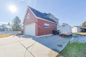 View of property exterior featuring a garage