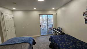 Bedroom featuring carpet flooring and access to outside