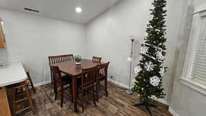 Dining area with dark hardwood / wood-style floors