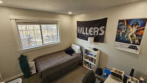 Bedroom with carpet flooring and a textured ceiling