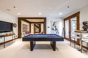 Playroom featuring french doors, light colored carpet, and pool table