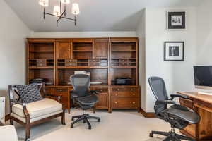 Office with a chandelier and light carpet