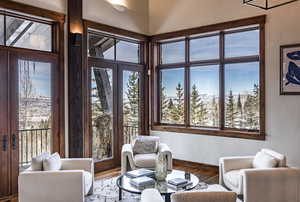 Living area with hardwood / wood-style floors, french doors, and plenty of natural light