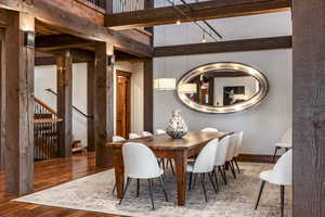 Dining room with hardwood / wood-style floors and a high ceiling