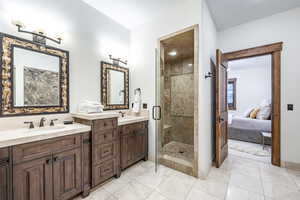 Bathroom with tile patterned flooring, vanity, and walk in shower