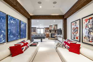 Playroom featuring carpet floors and a stone fireplace