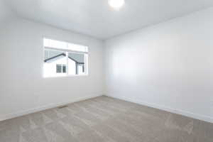 Spare room with light colored carpet