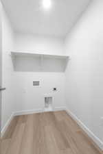 Laundry room featuring hookup for an electric dryer, hookup for a washing machine, and light wood-type flooring