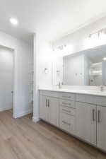 Bathroom featuring vanity, hardwood / wood-style flooring, and walk in shower