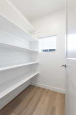 Walk in closet featuring wood-type flooring