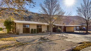 Ranch-style home with a carport and a mountain view