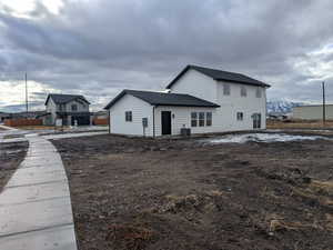 Back of property featuring a garage and central AC unit