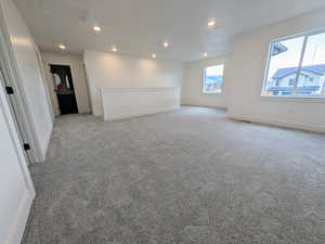 Empty room featuring light colored carpet