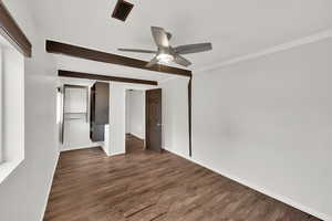 Unfurnished room featuring ceiling fan, dark hardwood / wood-style flooring, and beamed ceiling