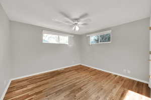 Unfurnished room with light hardwood / wood-style floors and ceiling fan