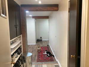 Bathroom with beam ceiling and wood-type flooring