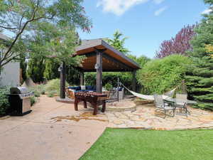 View of patio / terrace featuring a gazebo, a grill, and outdoor lounge area