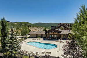 View of swimming pool featuring a mountain view and a patio