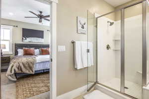 Bathroom with ceiling fan and a shower with door