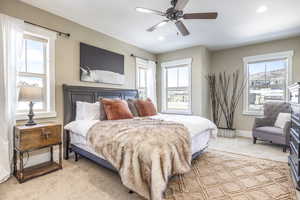 Carpeted bedroom featuring ceiling fan