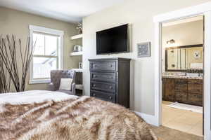 Tiled bedroom with ensuite bath