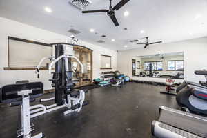 Exercise room featuring a textured ceiling and ceiling fan