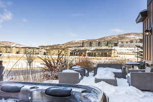 Exterior space with a mountain view and a hot tub