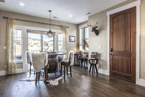 Dining room featuring dark hardwood / wood-style flooring and an inviting chandelier