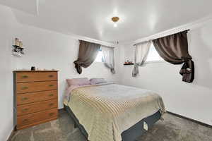 Bedroom featuring dark carpet