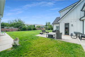 View of yard featuring a mountain view, a patio, and an outdoor living space