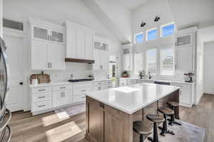 Kitchen featuring white cabinets, a kitchen island, and stainless steel gas stovetop