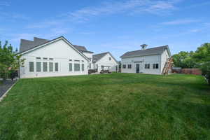 Back of house with a lawn