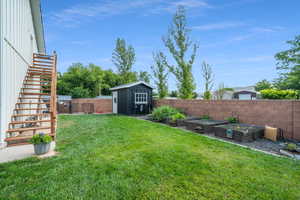 View of yard with a storage shed