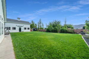 View of yard featuring a mountain view and a storage unit