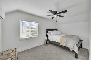 Bedroom featuring ceiling fan, lofted ceiling, light carpet, and a wall mounted AC