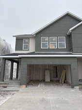 View of front facade featuring a garage