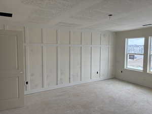 Unfurnished room with a textured ceiling