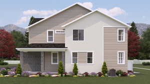 View of front facade featuring a mountain view and a front lawn