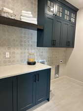 Washroom with cabinets and hookup for an electric dryer