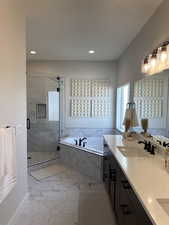 Bathroom featuring vanity and plus walk in shower