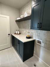 Kitchen featuring light tile patterned floors and backsplash