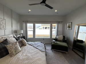 Carpeted bedroom featuring ceiling fan