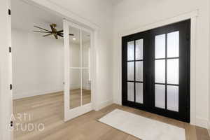 Interior space with ceiling fan, french doors, and hardwood / wood-style flooring