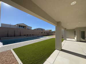 View of yard featuring a fenced in pool and a patio area