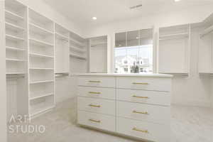 Spacious closet featuring light carpet