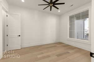 Empty room featuring ceiling fan and wood-type flooring