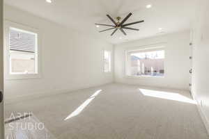 Carpeted empty room with ceiling fan