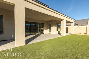 Back of property featuring a patio area and a yard