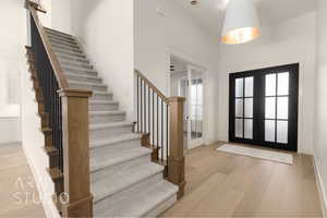 Foyer with french doors and light hardwood / wood-style flooring